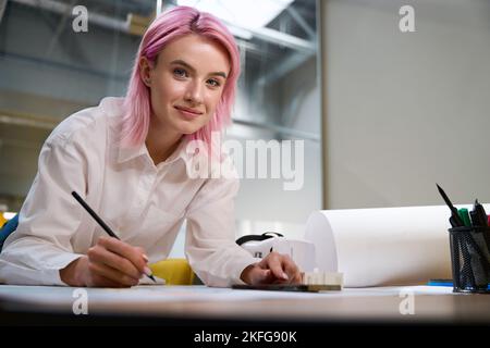 Female working in office, making notes on the project Stock Photo