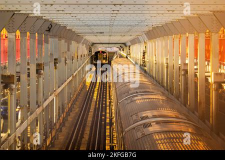 two subway trains passing each other on the M line on the Williamsburg bridge in Brooklyn NYC Stock Photo