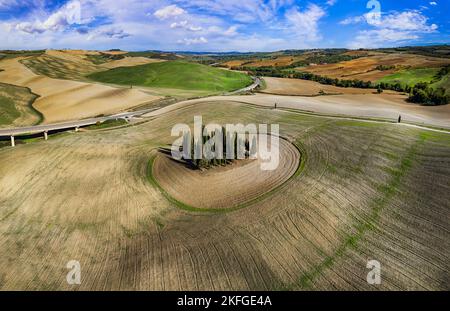 Italy landscape. Amazing Tuscany scenery. Typical countryside with vast fields of Val d'Orcia famous beautiful valley. Aerial drone shot of circle cyp Stock Photo