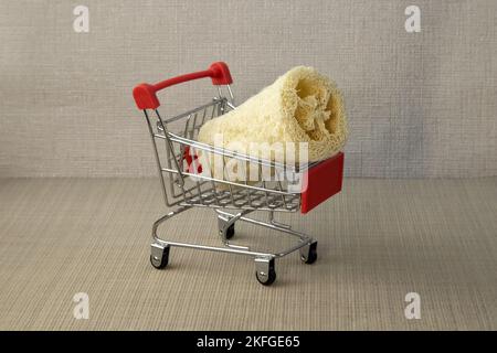 Natural environmental loofah designed for the body, lies on red background Close up Stock Photo