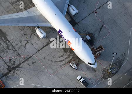 FedEx McDonnell Douglas MD-11 cargo aircraft. Freighter airplane of Fedex Express seen from above. Air cargo plane MD11. Stock Photo