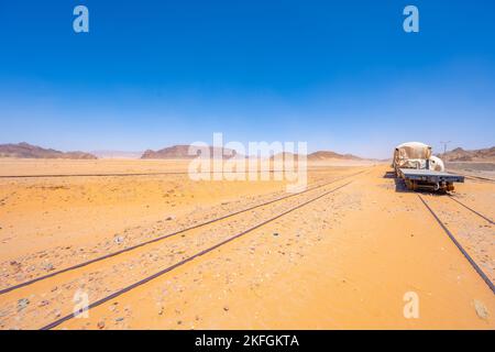 The sand buried train track at Wadi Rum Train Station in Wadi Rum Jordan Stock Photo