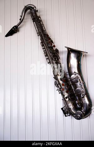 Very old silver saxophone on the white background Stock Photo