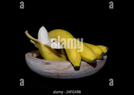 Yellow bananas on a black background. Stock Photo