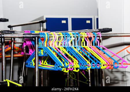 multi colored plastic hangers in the hardware store Stock Photo