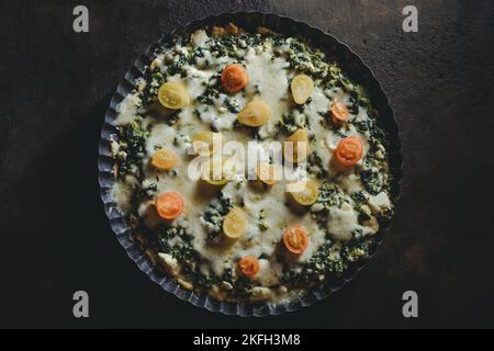 homemade tart pie with spinach, fresh tomatoes and basil leaves Stock Photo