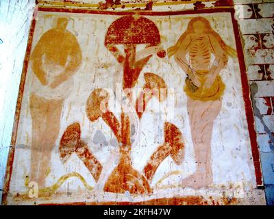 Temptation in the Garden of Eden, Chapel of Plaincourault, France, c. 1291  Fresco of Adam and Eve in the Garden of Eden, flanking a giant psychoactive Amanita muscaria mushroom, with a cluster of four mushrooms at the base, and the serpent offering Eve the fruit of the Tree of the Knowledge of Good and Evil.   Creative Commons Attribution-Share Alike 4.0 International license. Stock Photo