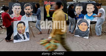 Kolkata, India. 18th Nov, 2022. A man passes by the posters where students paint a poster depicting soccer players Cristiano Ronaldo, Lionel Messi, Pele, Neymar, Kylian Mbappe, Harry Kane and Diego Maradona ahead of FIFA World Cup Qatar 2022 in Mumbai, India, 18 November, 2022. The FIFA World Cup Qatar 2022 will starts from 20th November 2022 to 18th December 2022. (Photo by Indranil Aditya/NurPhoto)0 Credit: NurPhoto/Alamy Live News Stock Photo