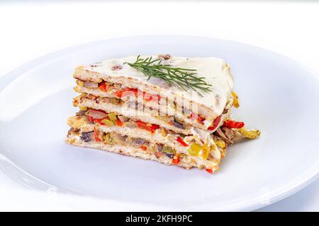 Pancake Pie from a Liver with Walnuts on the plate Stock Photo
