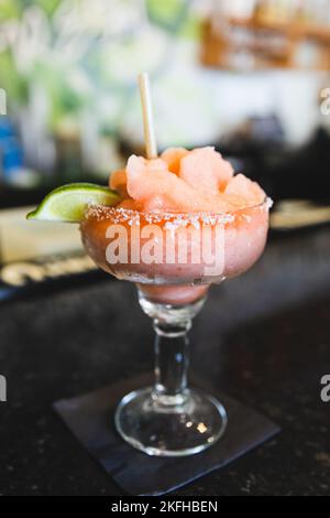A strawberry jalepeno frozen blended margarita at a local Mexican restaurant bar for cinco de mayo Stock Photo