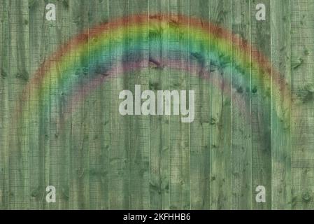 wooden fence panel. Textured, abstract backdrop with rainbow. Stock Photo