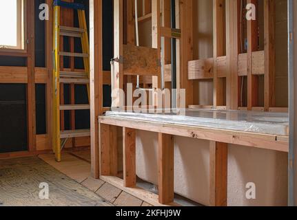 A bathroom in the middle of a remodel featuring the placement of a new bathtub. Stock Photo