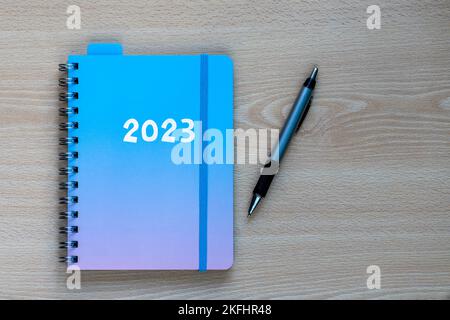 2023 diary to implement resolutions and new year plan on desk with a pen Stock Photo