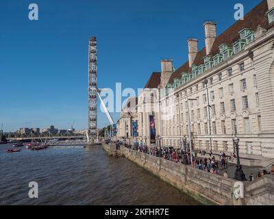 The London Eye on the banks of the River Thames beside County Hall, London, UK. Stock Photo