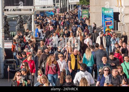 People walking along The Queens Walk beside the River Thames in London, UK. Stock Photo