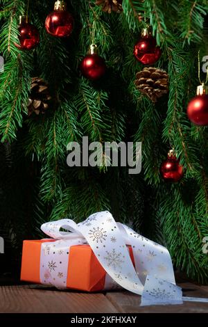 Christmas gift on the background of the Christmas tree close-up Stock Photo
