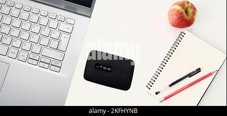 Top view work desk portable pocket internet wifi modem.Close up pocket modem, isolated white background on top of computer. access, background, batter Stock Photo