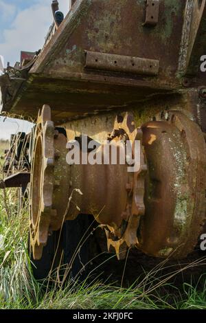 an abandoned rusting British FV4201 Chieftain main battle tank wreck in afternoon sunlight Stock Photo