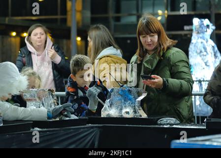 London, UK. 18th November, 2022. Participants have a go at creating an ice sculpture at the Winter Ice Festival, taking place across the Canary Wharf estate on three days - from Thursday 17th to the evening of Saturday 19th.  Visitors can observe large-scale ice sculptures being created, wander along the trail of 15 frozen endangered animals, and can take part in hands-on activities, sculpting their own polar bear or carving on an icy grafitti wall.  Credit: Eleventh Hour Photography/Alamy Live News Stock Photo