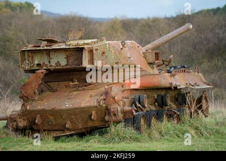 an abandoned rusting British FV4201 Chieftain main battle tank wreck in afternoon sunlight Stock Photo