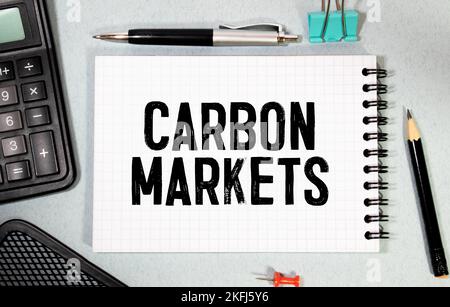 CARBON MARKETS. text on white paper near dollar bills. Stock Photo