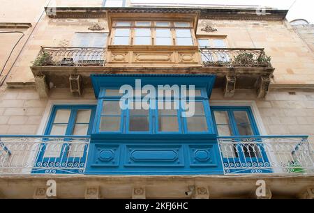 Valletta, Malta - November 12, 2022: Residential building facade with colorful traditional wooden and iron balconies in Malta's capital city Stock Photo