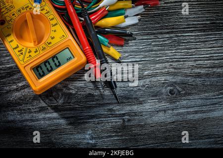 Electric wires multitester on vintage wooden board. Stock Photo