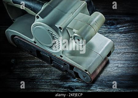 electric hand tool belt detail sander on vintage wood Stock Photo