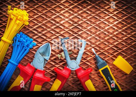 Insulation wire strippers cutter tying cables electric tester on dielectric mat. Stock Photo