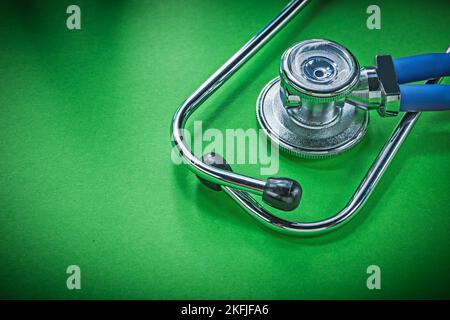 Medical auscultator for checkup on green background Stock Photo - Alamy