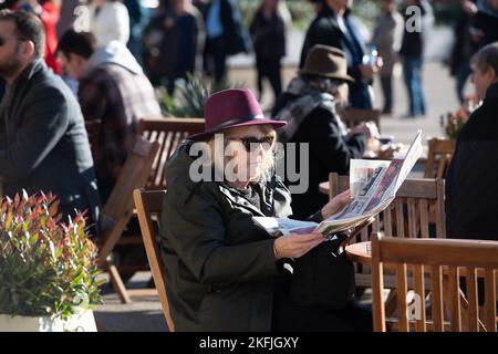 Ascot, Berkshire, UK. 18th November, 2022. A lady relaxes in the sunshine at Ascot Races. Credit: Maureen McLean/Alamy Live News Stock Photo