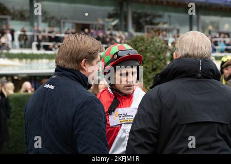 Ascot, Berkshire, UK. 18th November, 2022. Jockey Harry Skelton in the Parade Ring with trainer Dan Skelton before riding in the Royal Ascot Racing Club Handicap Steeple Chase at Ascot Racecourse. Credit: Maureen McLean/Alamy Live News Stock Photo