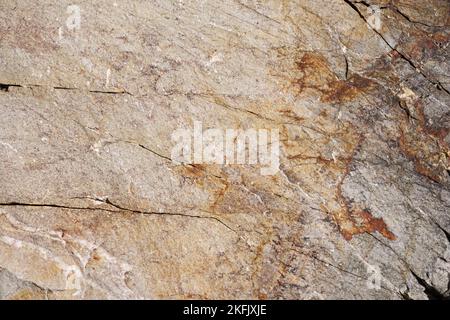 tan and gray quartzite rock background texture with cracks Stock Photo