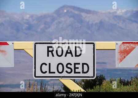 road closed sign on a metal gate with out of focus Mount Tom in the background Stock Photo