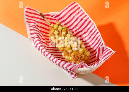 Delicious Crunchy Korean Style Chunky Potato Corn Dogs with Batter and Cubed Fried Potatoes. Stock Photo