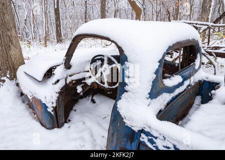 Old rusted truck in the woods on a snowy morning. Stock Photo