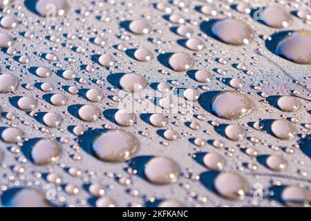 Shiny water drops on metallic surface. Water drops texture background. Stock Photo