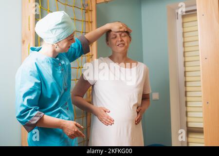 Pregnant woman trying to breath to soothe the pain of her labor contractions Stock Photo