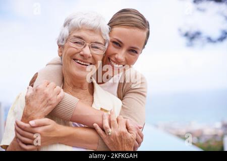 She means everything to me. Portrait of an affectionate mother and daughter standing outdoors. Stock Photo