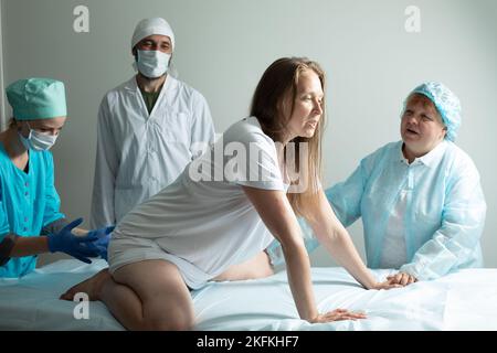 Child birth process, helping personal during labour Stock Photo