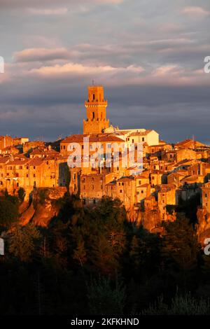 Close up and detail of medieval town Pitigliano glowing  in evening light with cathedral Santi Pietro e Paolo and tower in the centre, Maremma, Provin Stock Photo