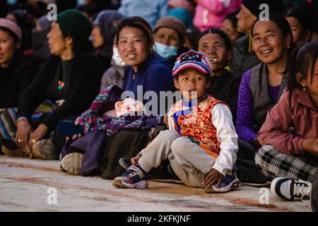 A Young family watching ancient Tibetan Buddhist Tiji Festival in Lo Manthang, Upper Mustang, Nepal Stock Photo