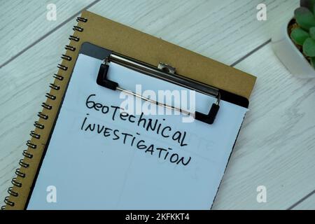 Concept of Geotechnical Investigation write on paperwork isolated on Wooden Table. Stock Photo