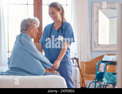 Retirement, healthcare and old woman with nurse in bedroom for support, rehabilitation and disability. Help, medical and consulting with caregiver and Stock Photo