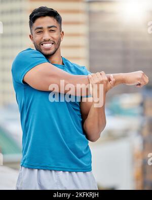 Fitness, exercise and stretching with a sports man doing a warm up before a workout or training routine. Portrait, health and stretch with a male Stock Photo
