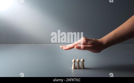 hand protecting  the family gray background , Family care concept ,Home loan, home insurance, family life assurance protection, financial mortgage for Stock Photo
