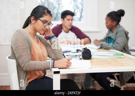 Shes diligent in her studies. three university students studying. Stock Photo