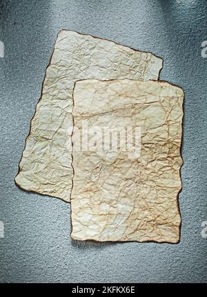 Aged sheets of paper on grey background. Stock Photo