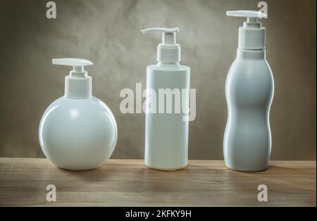 body hygiene products three pump dispensers mockup blank white plastic bottles Stock Photo