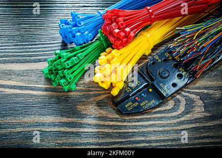Bunch of electric wires tying cables bolt cutter on wooden board. Stock Photo